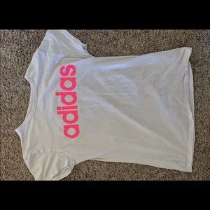 A white shirt with an Adidas logo on it